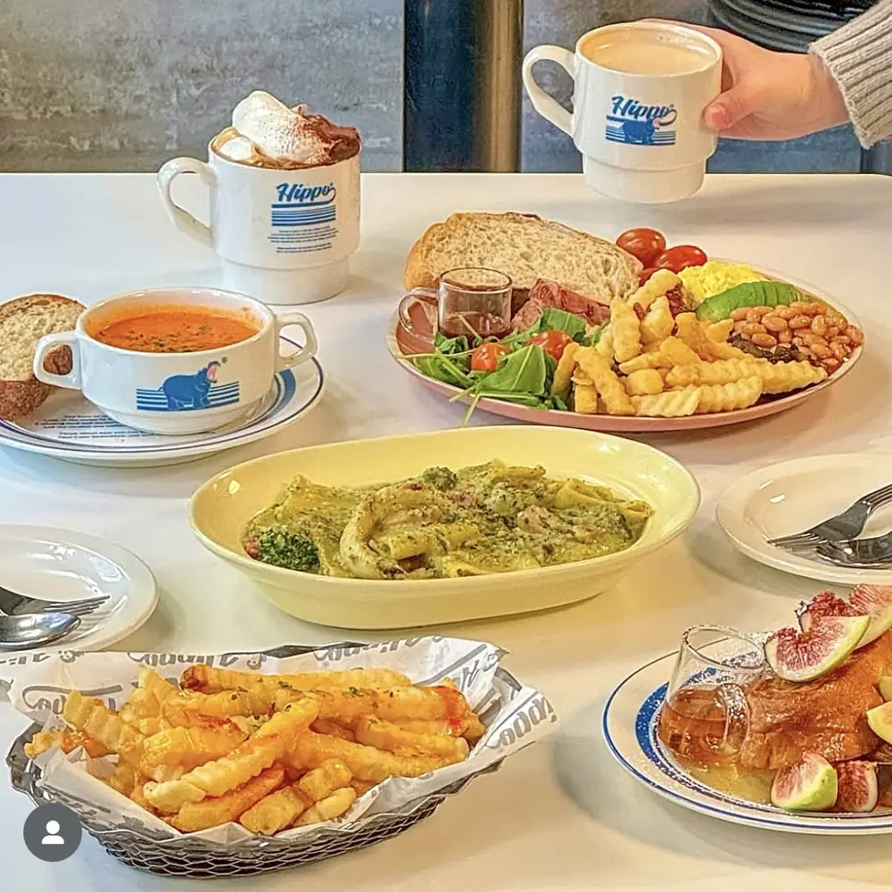 Hippo mugs of coffee with tomato soup, basil cream paccheri and a basket of fries