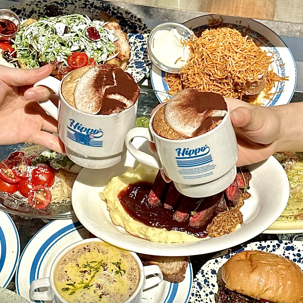 Two Hippo Vienna coffees beside steak, salad and pasta at Hippo Brunchaus